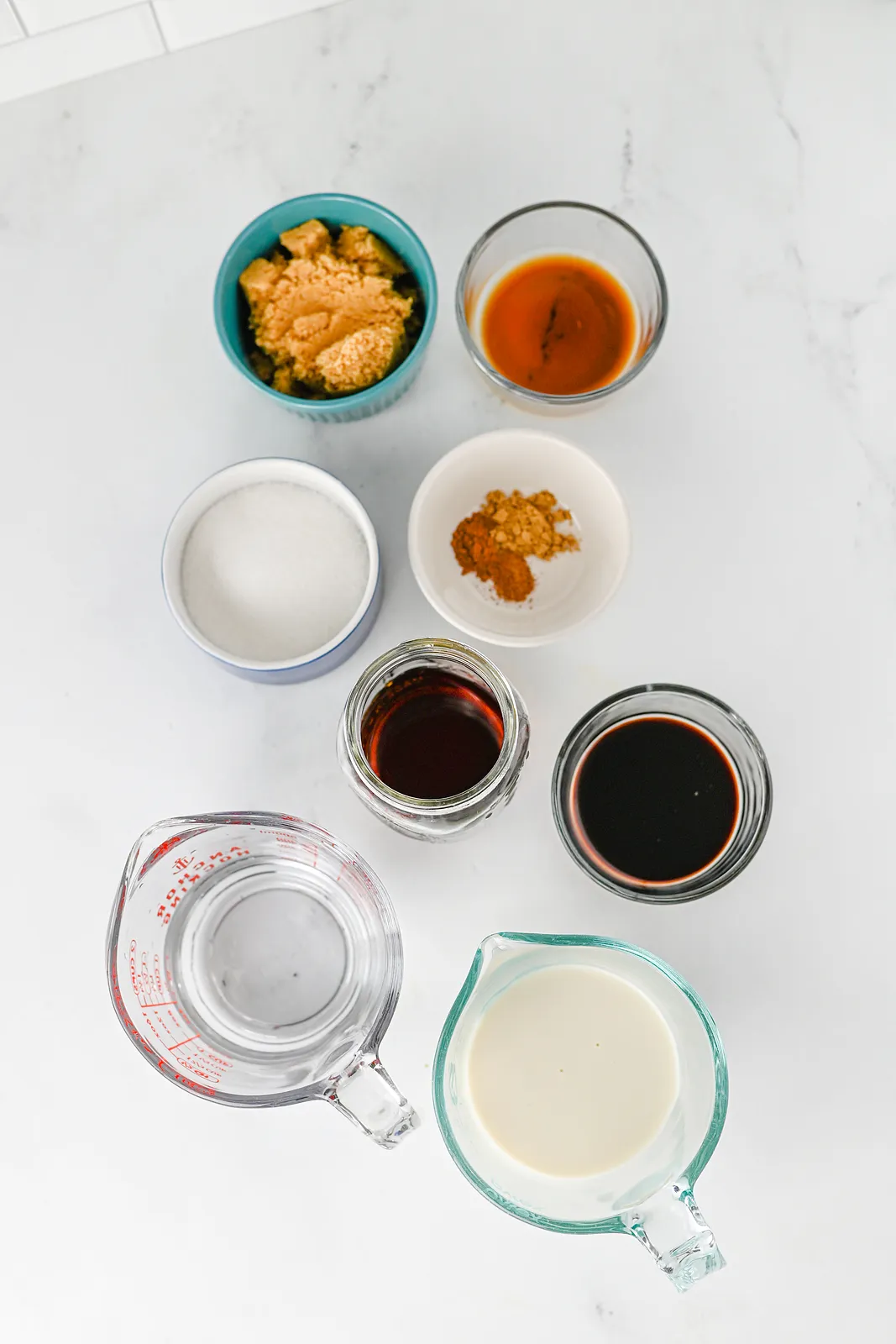 Ingredients for gingerbread chai: brown sugar, white sugar, molasses, ground ginger, cinnamon, vanilla, water, oat milk and chai concentrate