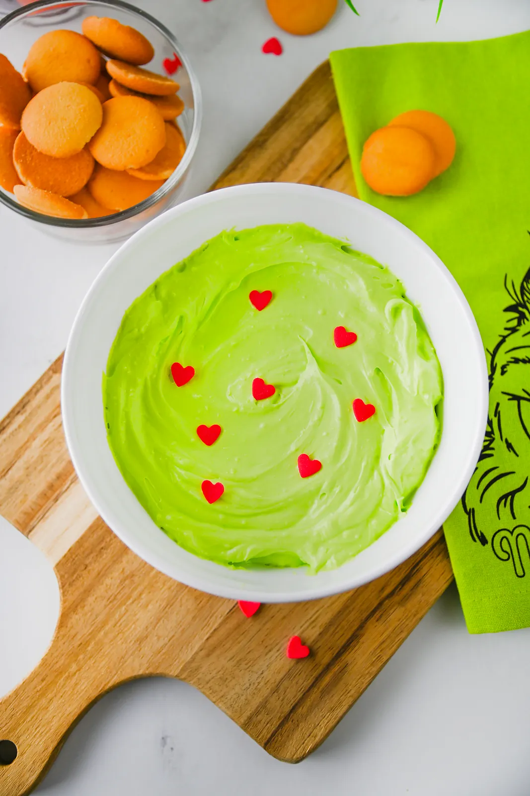 Bright green fluff with red hearts in a white bowl from above