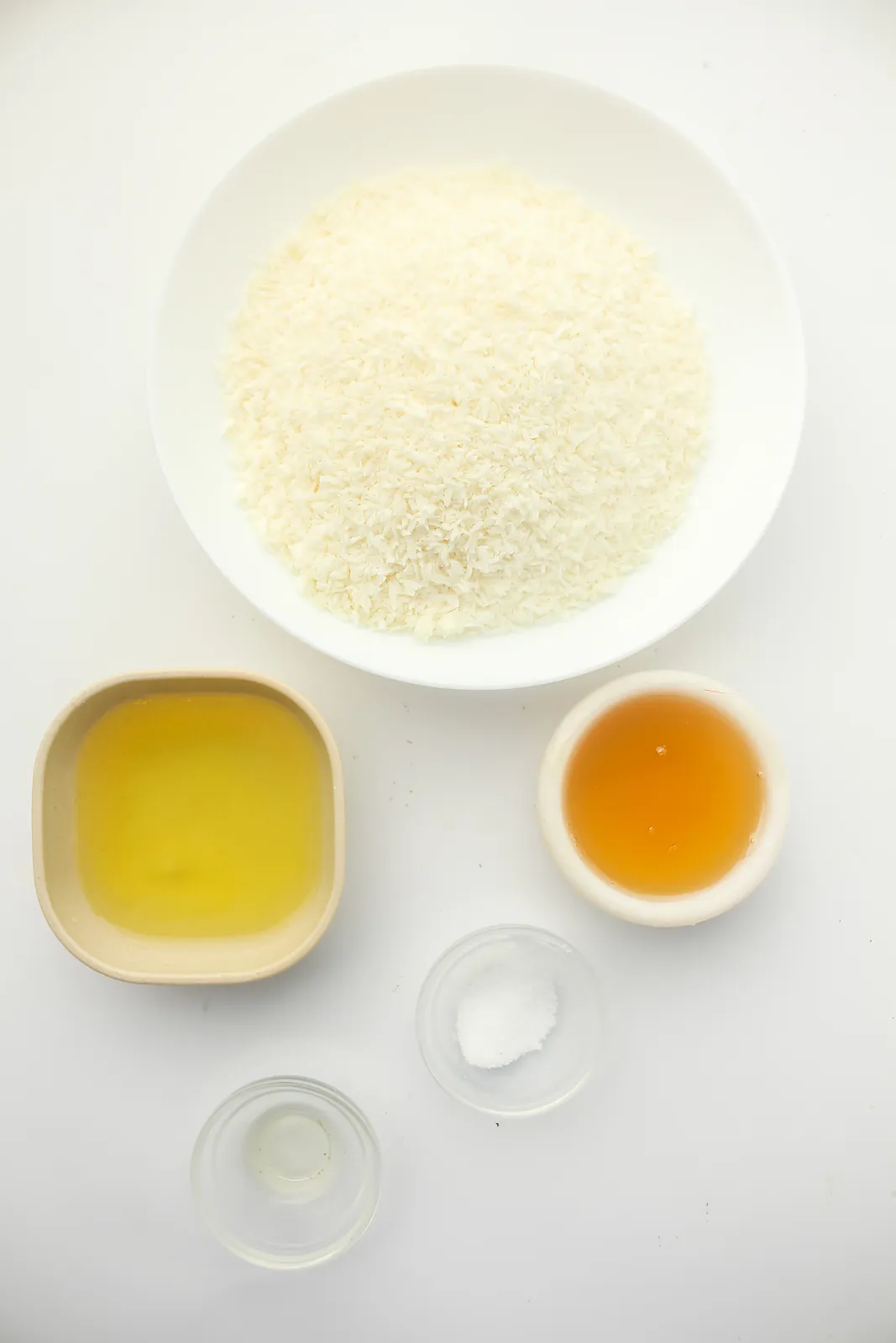 Ingredients for coconut macaroons: desiccated coconut, egg whites, honey, vanilla and salt