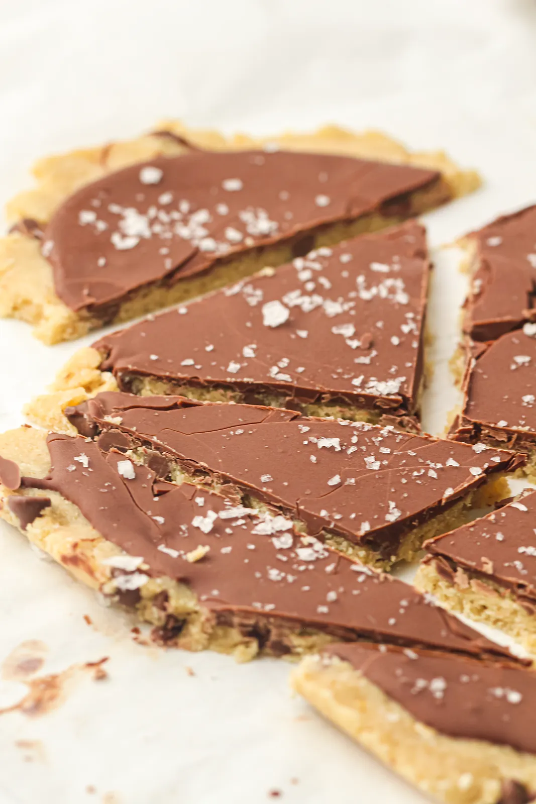 Squares of chocolate topped cookie dough bark with flaky salt