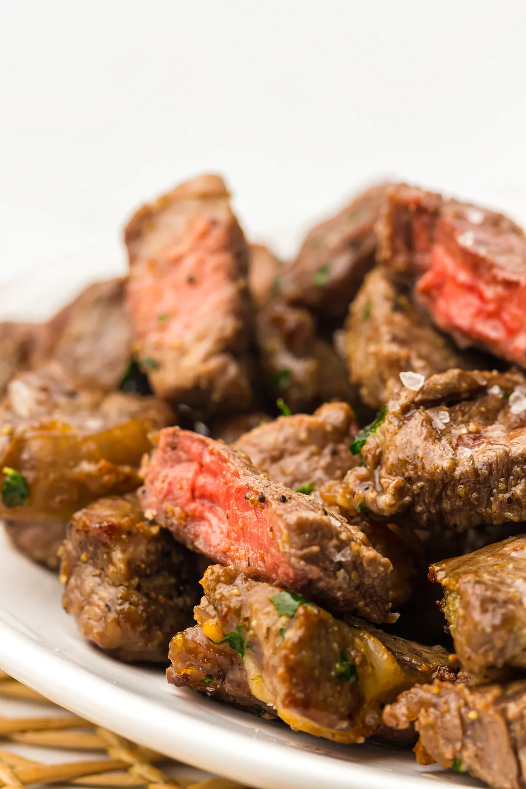 Close up of seared ribeye cubes cut open to show rosy pink centres