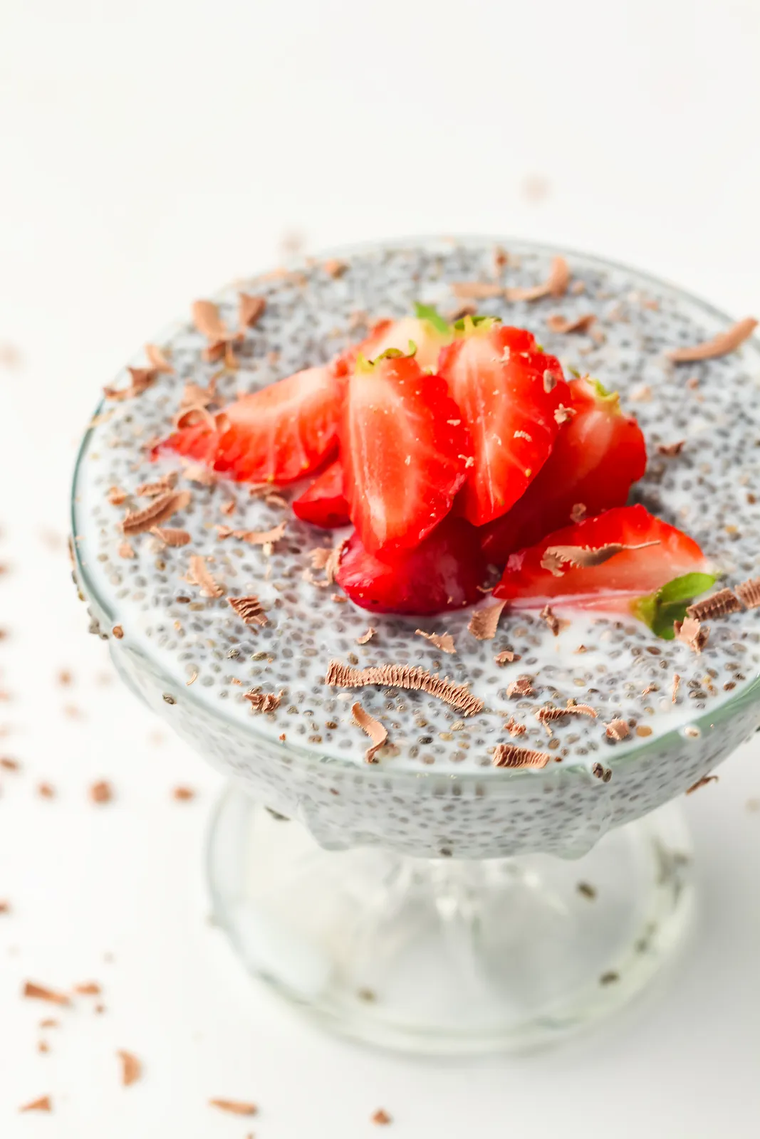 Strawberries and chocolate shavings scattered over a creamy seeded breakfast