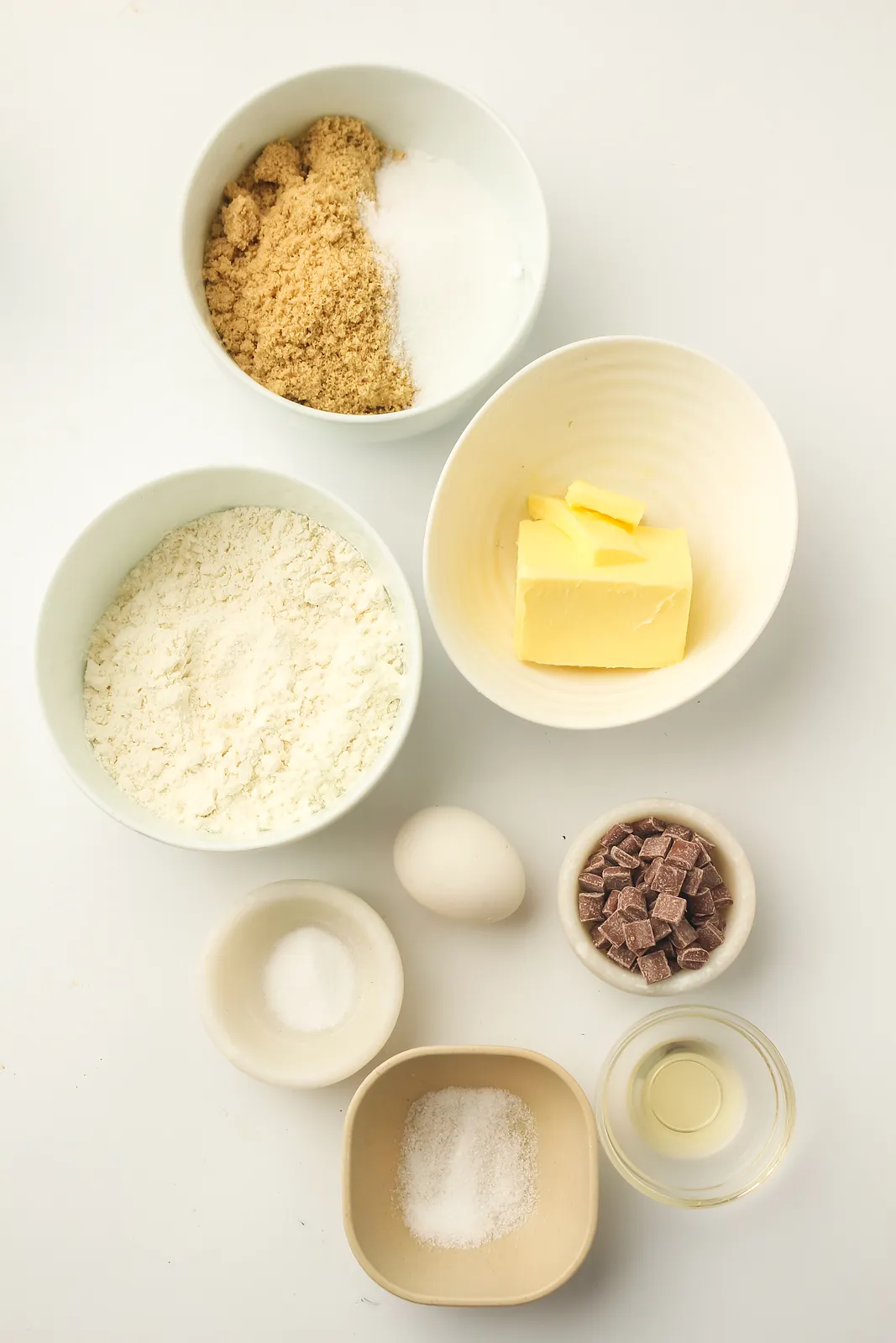 Ingredients for a skillet cookie: butter, brown and white sugar, flour, egg, vanilla, salt, bicarbonate and chocolate