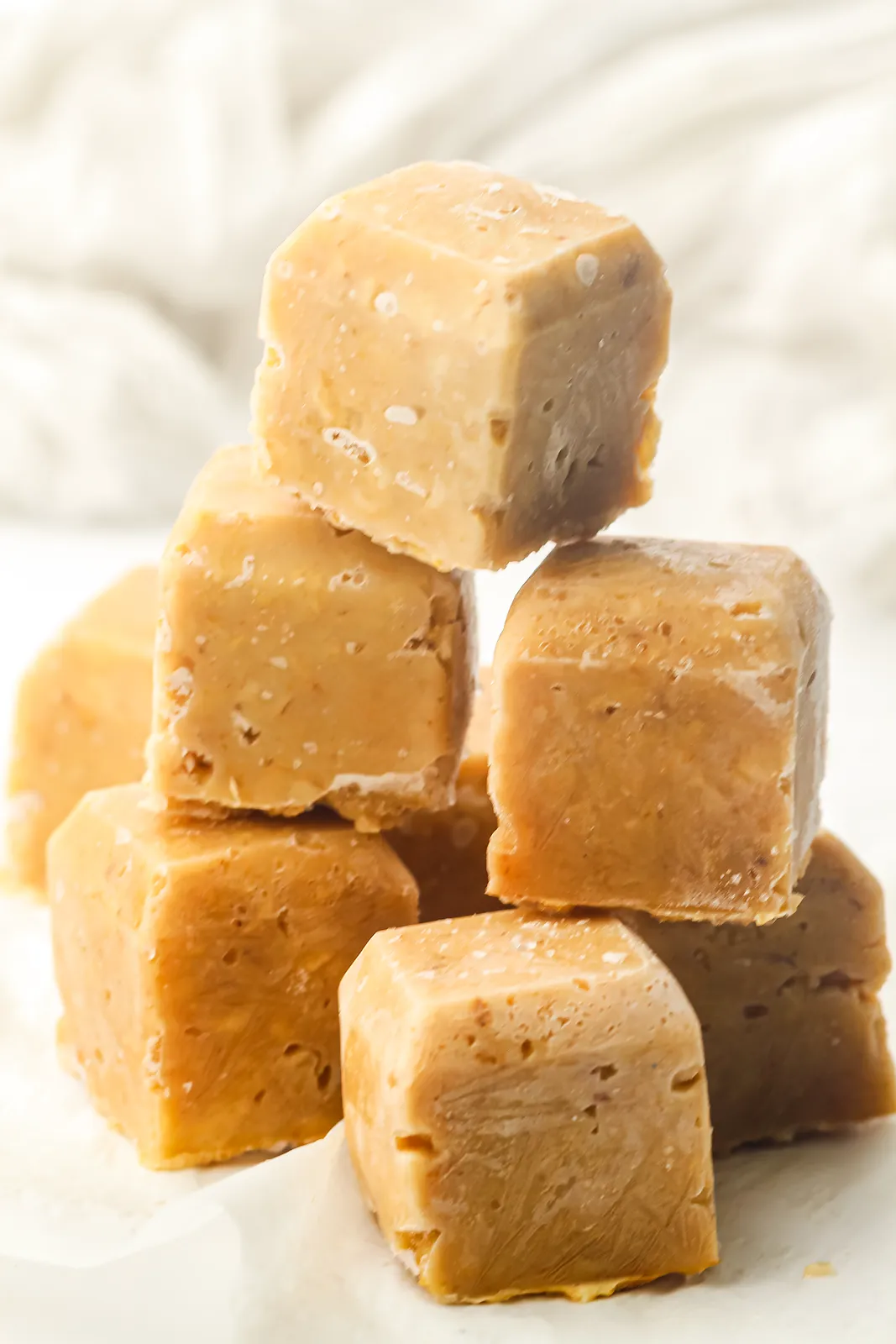 A pile of golden cinnamon porridge blocks on a white surface