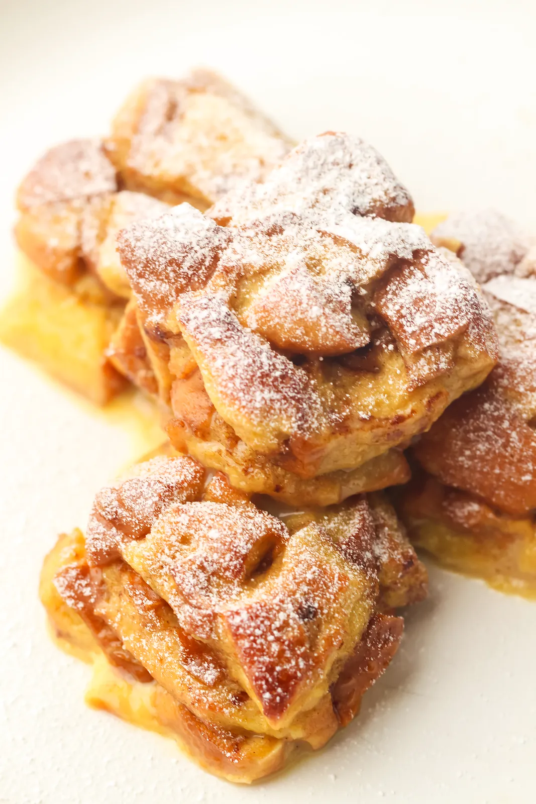 Close up of caramelised brioche bites dusted with icing sugar