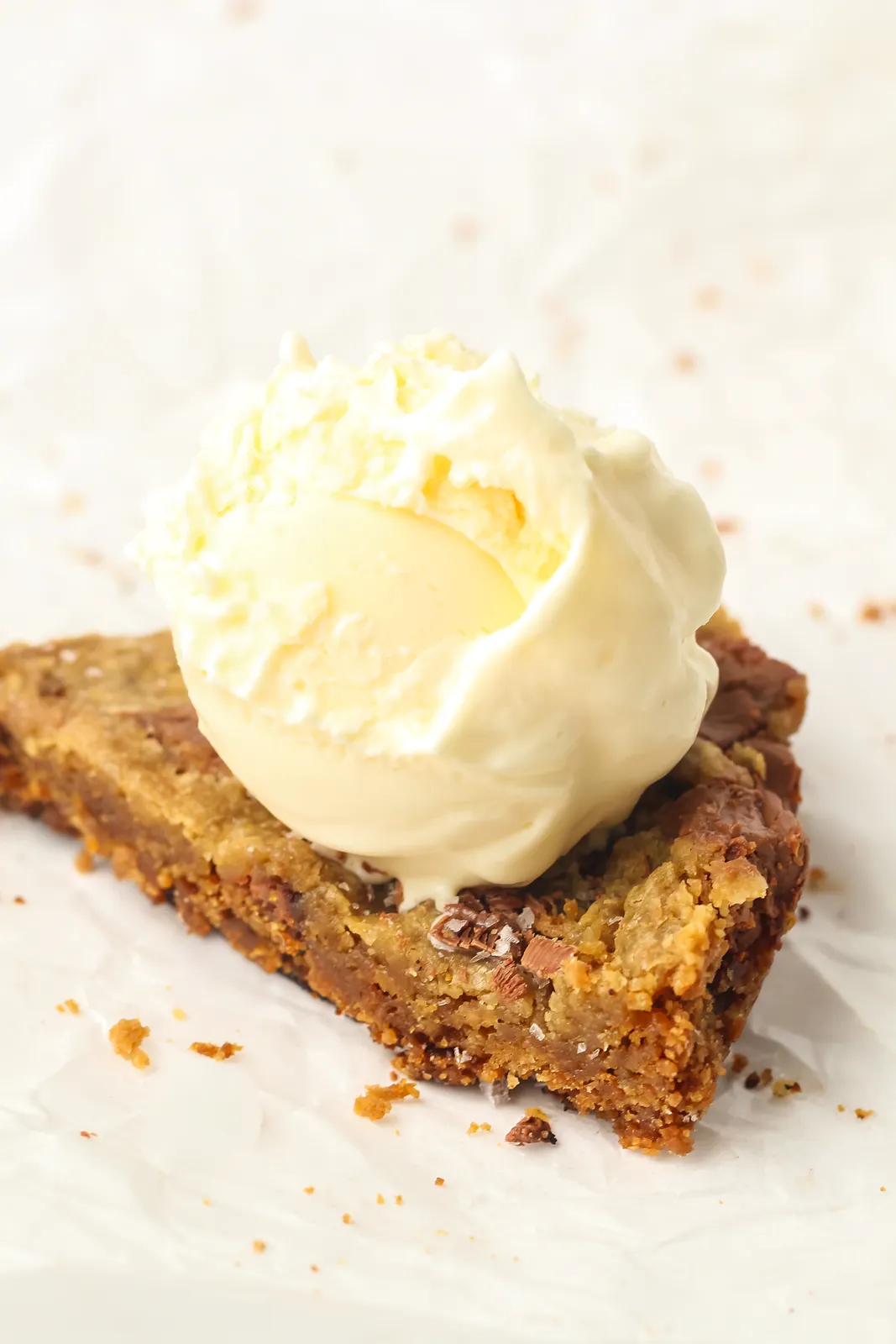 Vanilla ice cream softening on top of a warm chocolate chunk wedge